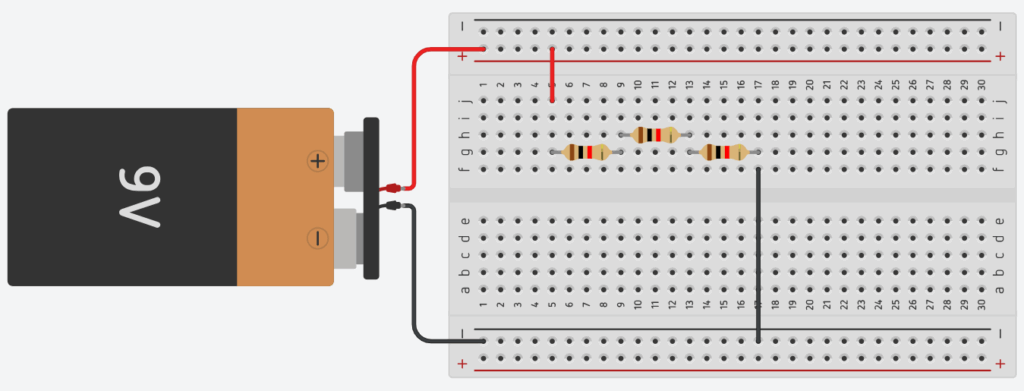 Circuito com três resistores em série conectados em uma protoboard alimentada por uma bateria de 9V.
